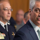 Interim Chicago Police Superintendent John Escalante (left, background) listens as Chicago Mayor Rahm Emanuel addresses upcoming changes in training and procedures within the Chicago Police Department on Dec. 30, 2015.
Scott Olson/Getty Images